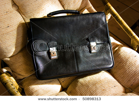 stock-photo-black-briefcase-on-a-wicker-chair-50898313