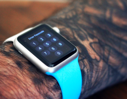 B Apple Watch on tatooed wrist